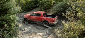 Red-2021-Ford-Ranger-driving-on-a-muddy-road-1024×464-1.jpg